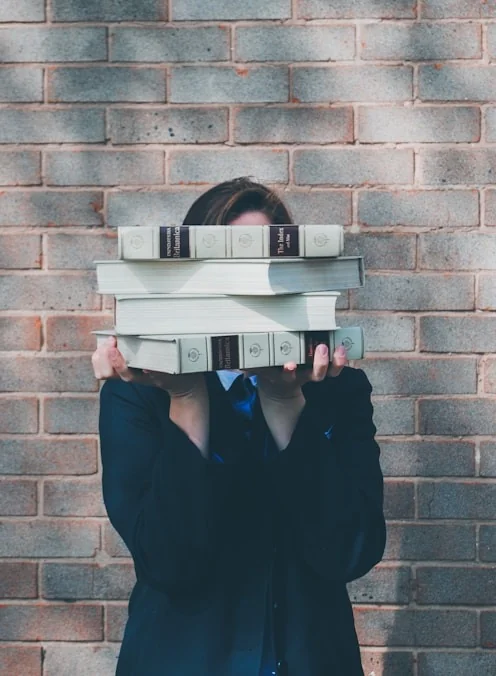 Student holding stack of books